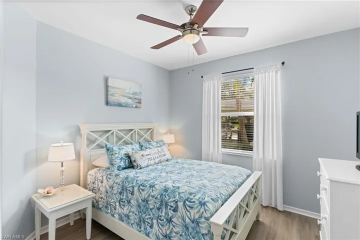 Bedroom with wood finished floors and ceiling fan