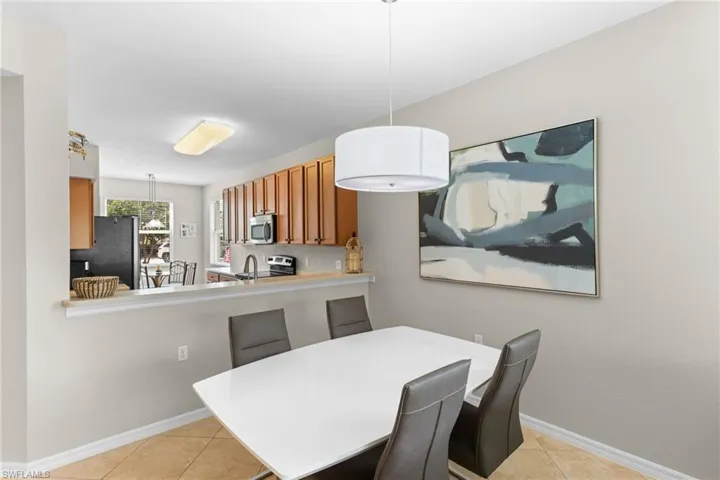 Dining space with baseboards and light tile patterned floors