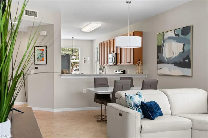 Living room with baseboards and light tile patterned floors