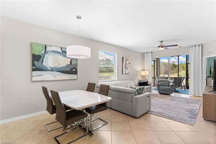 Dining room with ceiling fan and light tile patterned floors