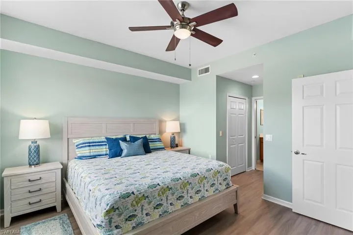 Bedroom featuring dark wood finished floors, a closet, and ceiling fan