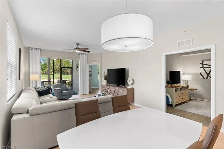 Living room featuring a ceiling fan and light wood-style flooring