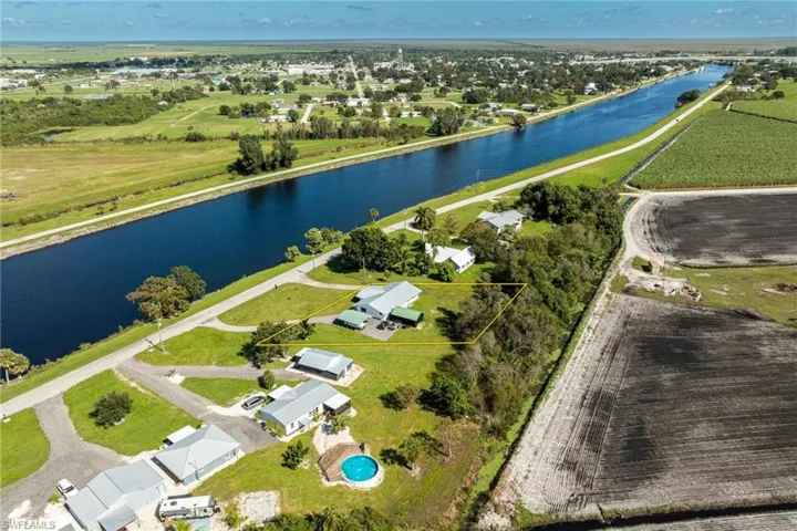 Birds eye view of property featuring the Caloosahatchee River!