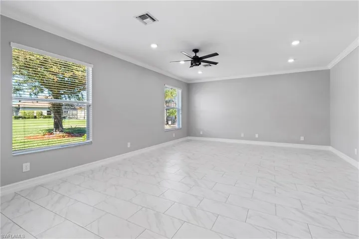 Spare room featuring crown molding and ceiling fan