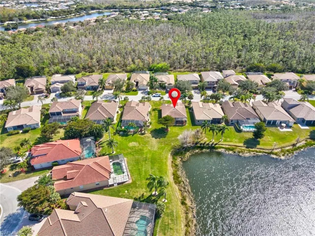 Birds eye view of property with a water view