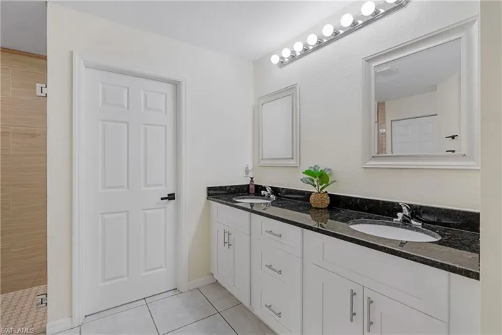 Bathroom with tile flooring and double vanity
