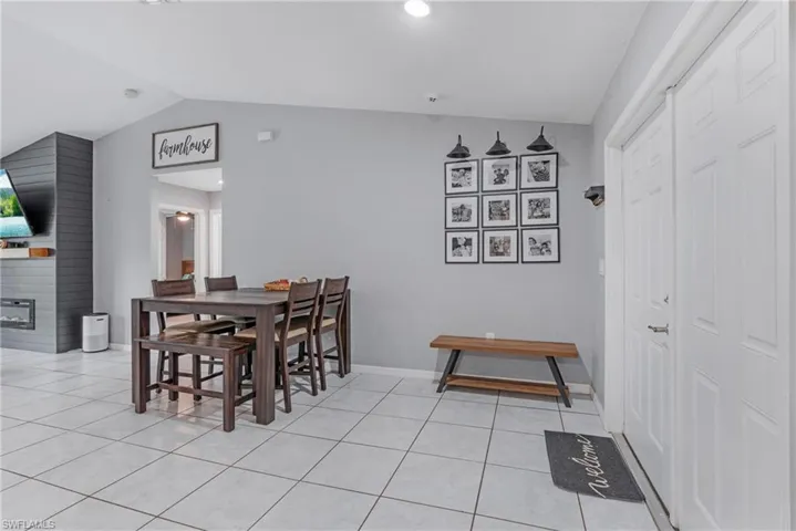 Tiled dining area with lofted ceiling