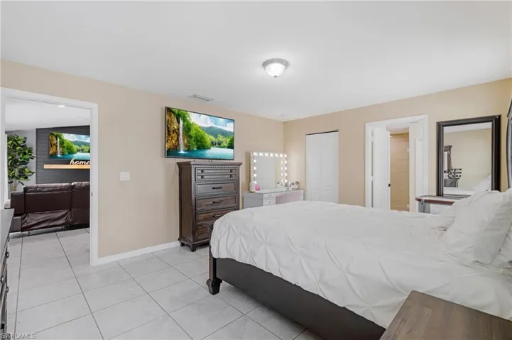 Tiled bedroom featuring a closet