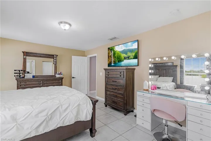 Bedroom with light tile flooring