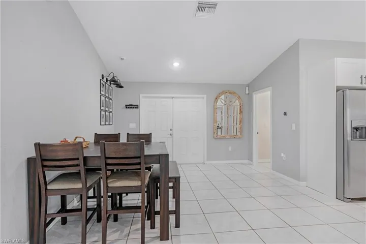 Tiled dining space with vaulted ceiling