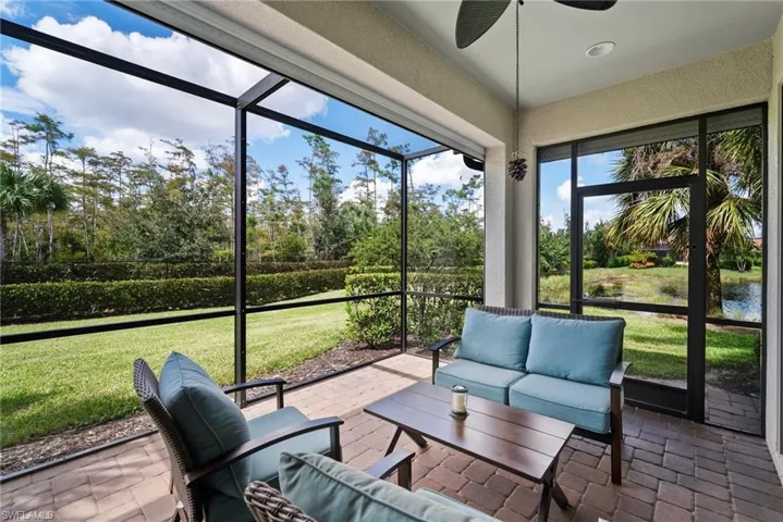 Sunroom / solarium featuring a water view
