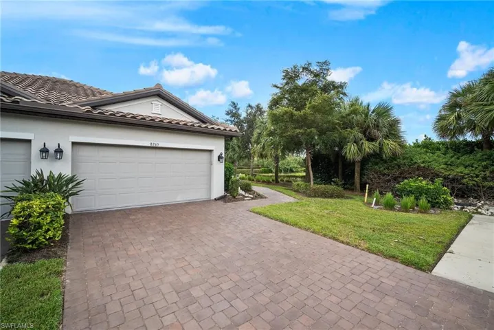 Garage featuring a lawn