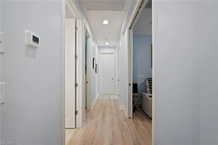 Corridor with light hardwood / wood-style floors