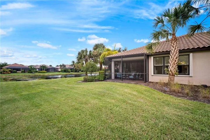 View of yard with a water view and a sunroom