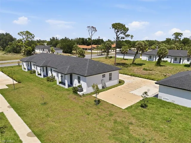 Contemporary white stucco exteriors with dark shingle roofing