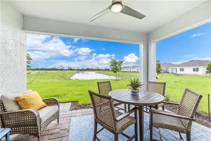 View of patio / terrace featuring a water view and ceiling fan