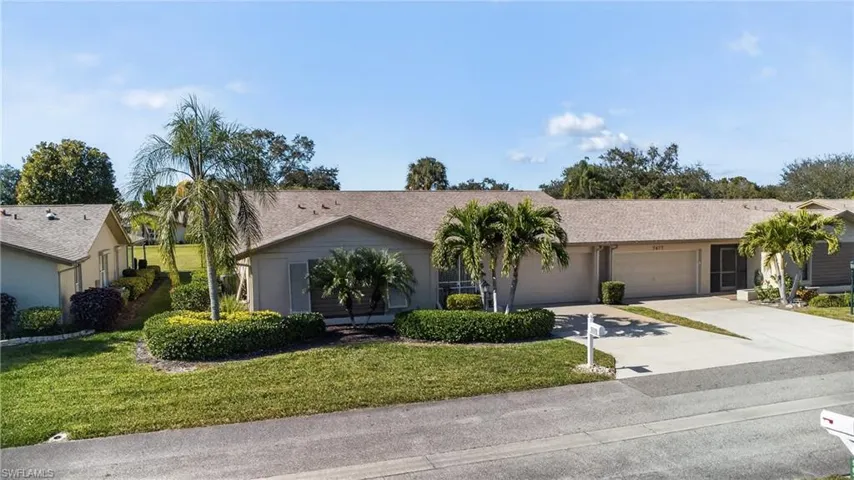 Single story home featuring driveway, a front lawn, and an attached garage