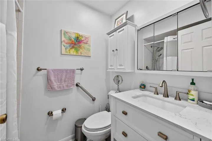 Full bathroom with vanity and curtained shower