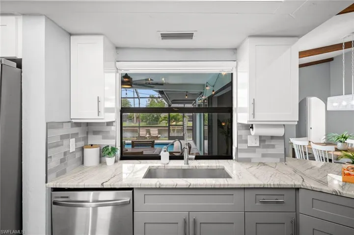 Kitchen with a view of the lanai, pool and canal