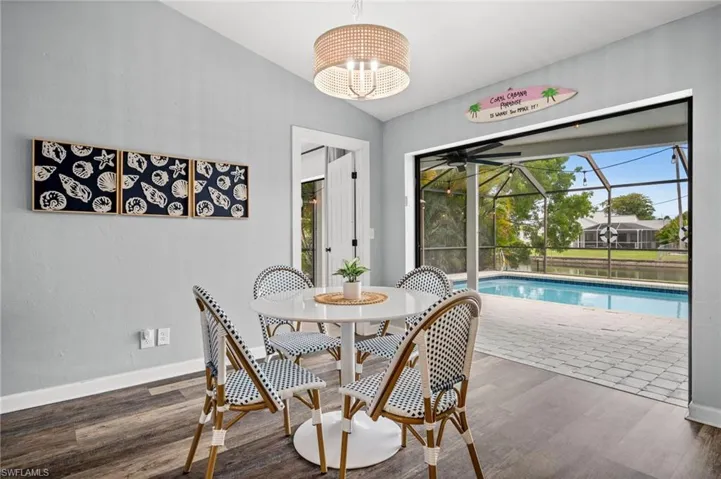 Dining area open to the lanai and pool