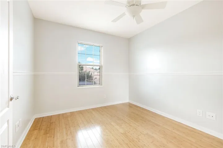 Light wood-finish flooring with crisp white baseboards
