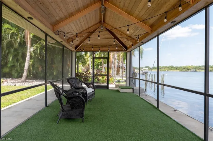 Unfurnished sunroom featuring a water view