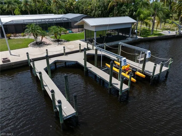 View of dock with boat lift and a water view