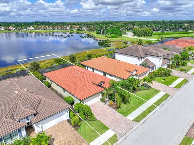 Aerial view of residential area featuring a large body of water