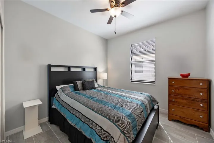 Bedroom with baseboards and a ceiling fan