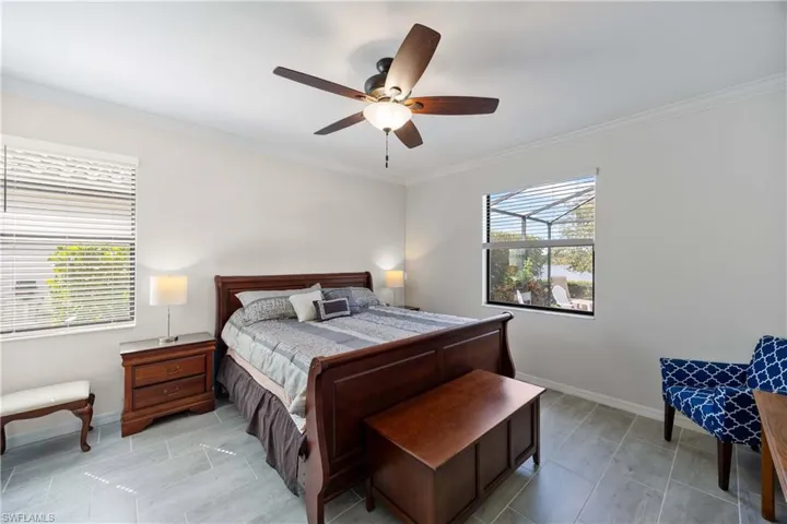 Bedroom with ornamental molding and ceiling fan