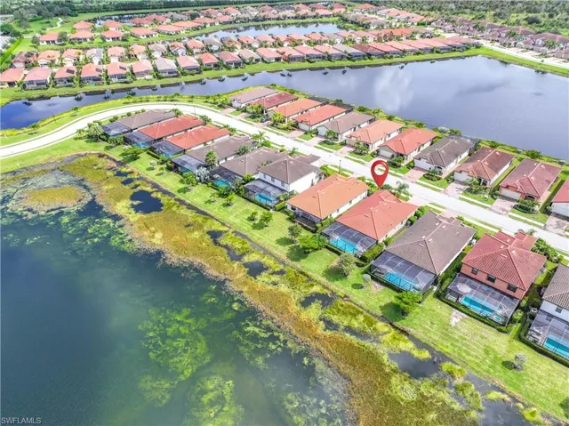 Aerial view of residential area featuring a large body of water