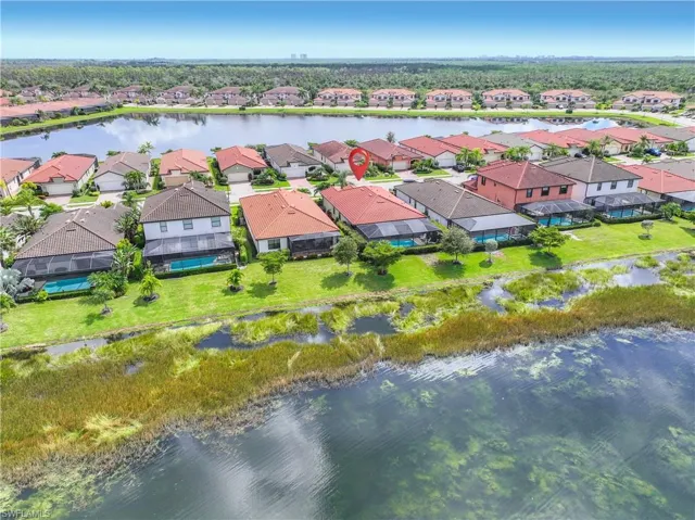 Aerial view of residential area featuring a large body of water