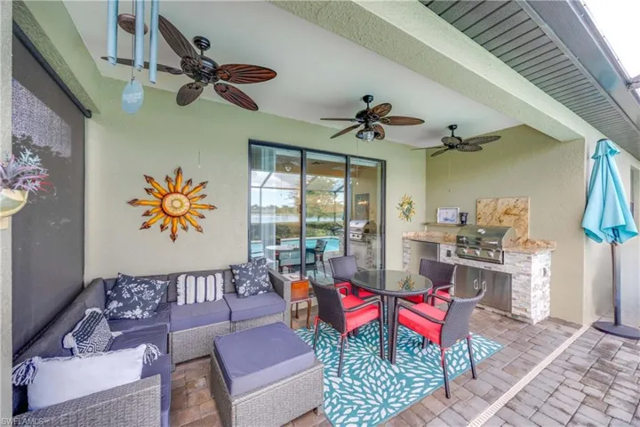 View of patio featuring outdoor dining area and an outdoor kitchen
