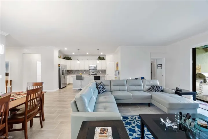 Living area with ornamental molding and recessed lighting