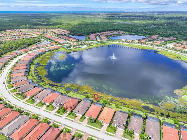 Aerial view of property's location featuring nearby suburban area and a nearby body of water