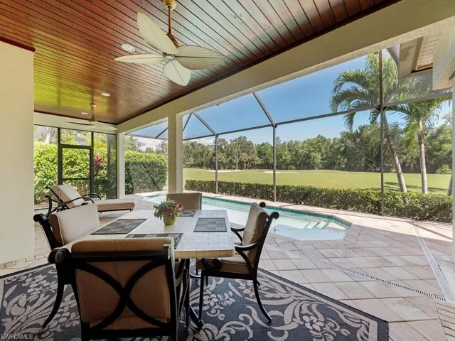 Sunroom with a ceiling fan and a swimming pool