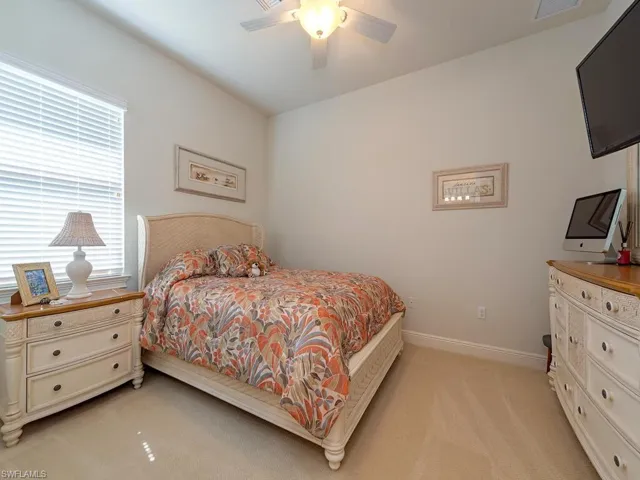 Bedroom with visible vents, a ceiling fan, baseboards, and light colored carpet