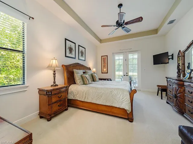 Bedroom with light carpet, access to outside, french doors, and visible vents