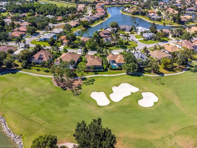 Drone / aerial view with golf course view, a residential view, and a water view