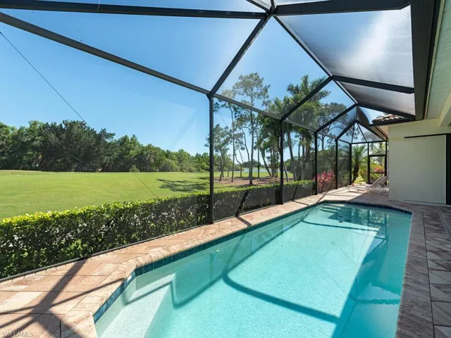 Outdoor pool featuring a yard and a lanai