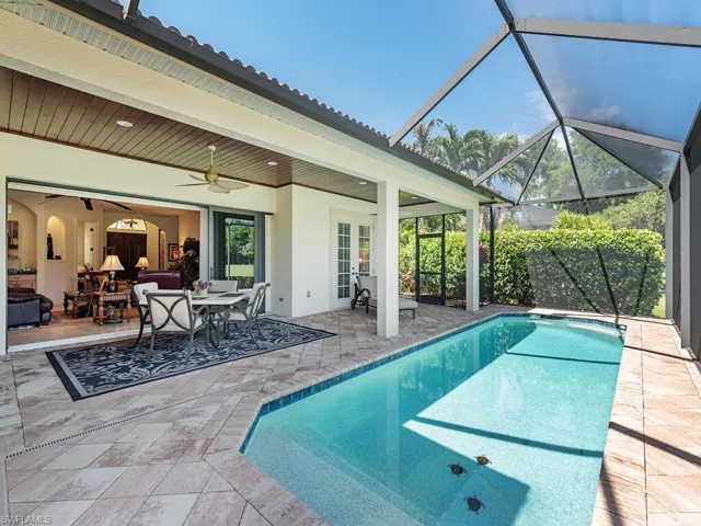 Pool with french doors, a patio area, a lanai, and a ceiling fan