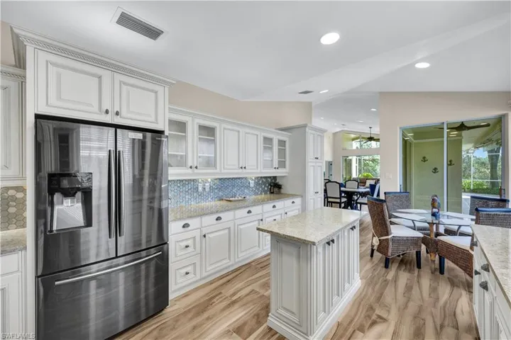 Stainless appliances, white cabinetry, gorgeous countertops and backsplash - this kitchen has it ALL!