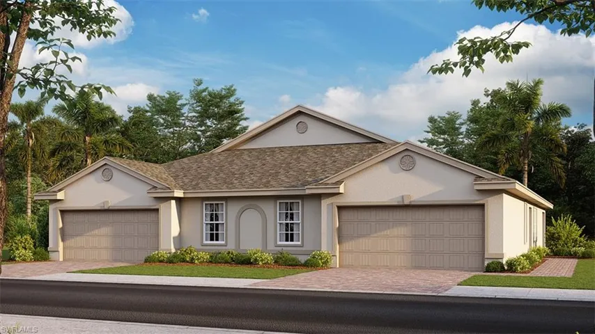 Ranch-style house featuring a garage and a front lawn
