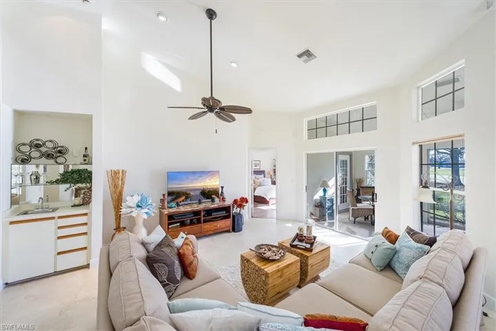 Living area with wet bar and looking out to lanai