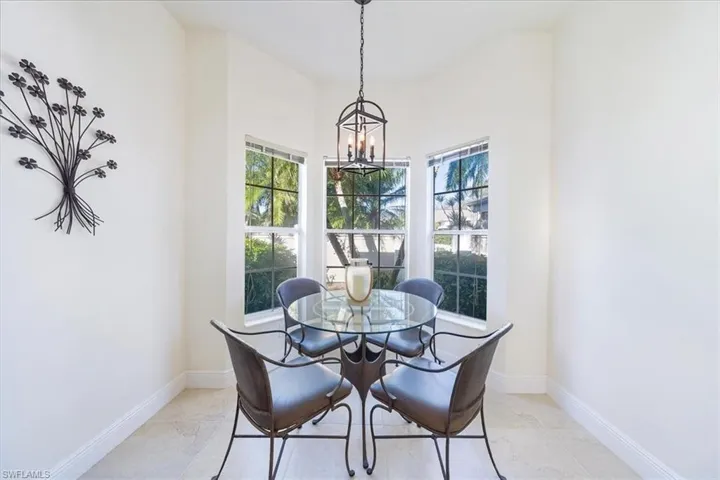Kitchen eating area with Bay window looking out to private courtyard entrance.