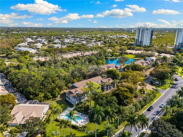 Bird's eye view of a pool area and a nearby body of water