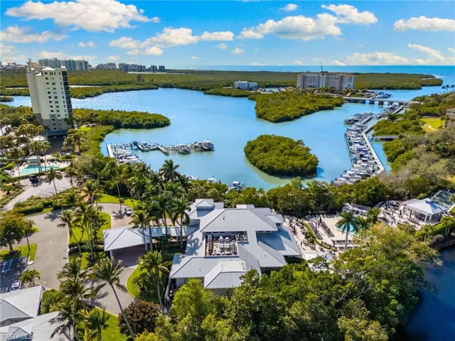 View of urban area with a large body of water and a marina