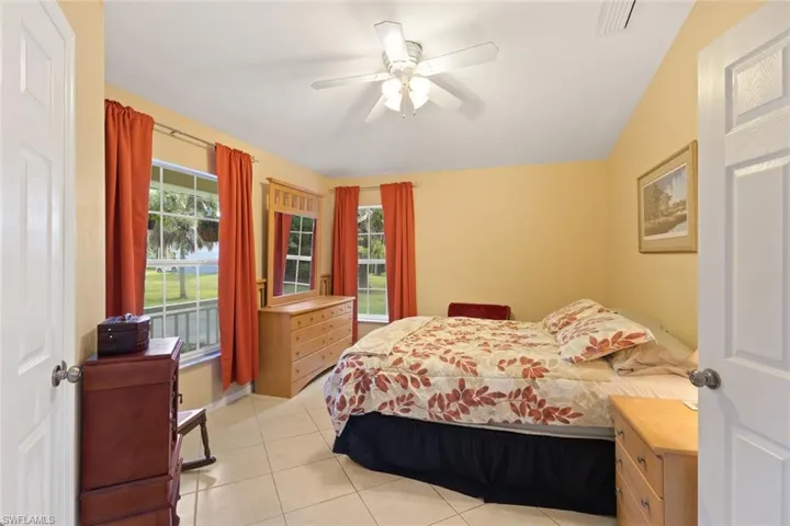 Bedroom featuring light tile patterned flooring and a ceiling fan
