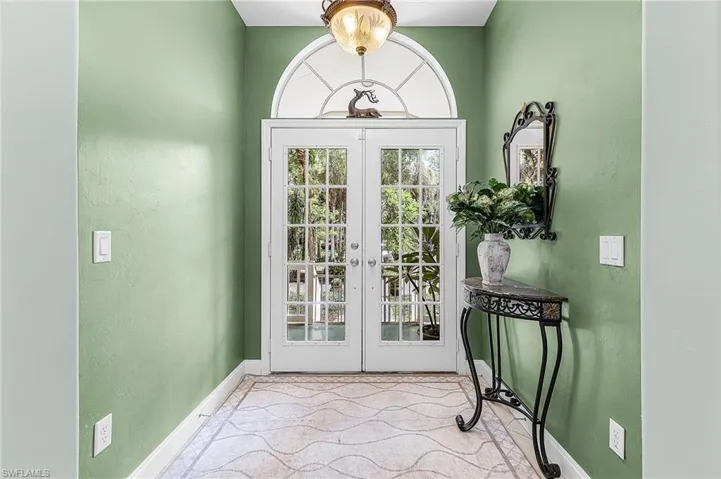Entryway featuring french doors and a textured wall