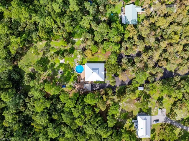 Aerial view of property's location with a pool area